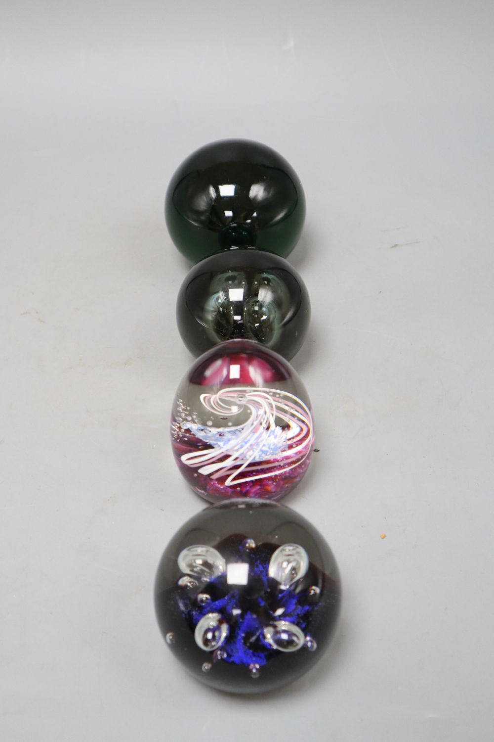 Four glass paperweights